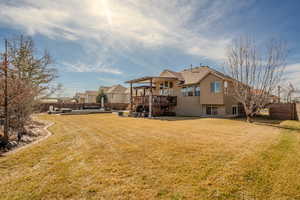 Rear view of property with a wooden deck, a residential view, and a patio