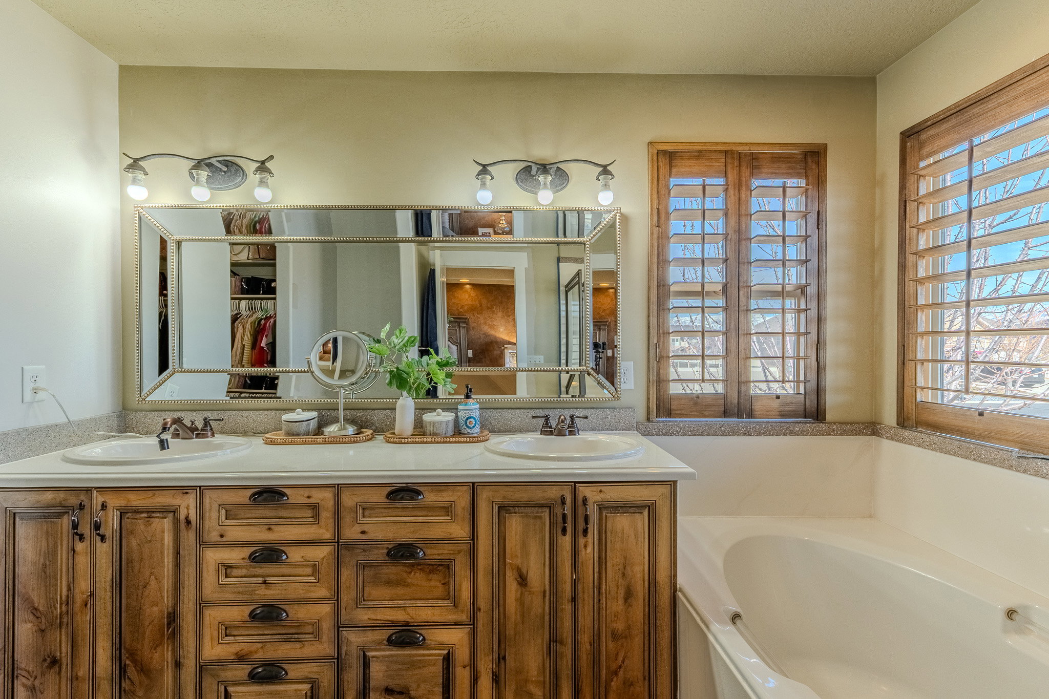 Bathroom featuring double vanity and a garden tub