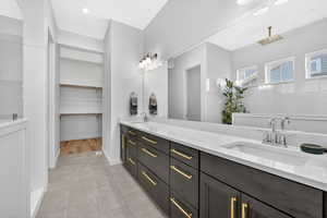 Owners full bath featuring double vanity, a spacious closet, and large walk in shower