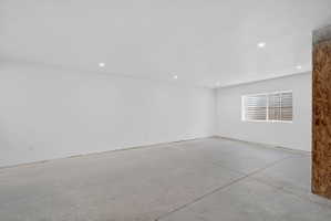 Spare room with concrete floors and recessed lighting