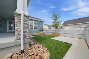 View of yard featuring a covered patio area (grass has been seeded and will be grown in within the next month this grass is virtual)