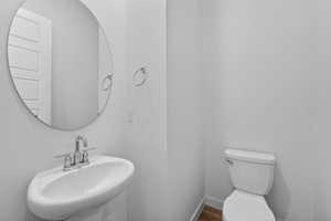 Half bathroom featuring a sink and toilet