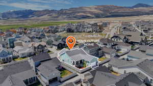 Aerial perspective of suburban area featuring a mountain backdrop