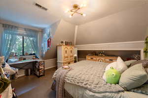 Bedroom with carpet floors and a chandelier