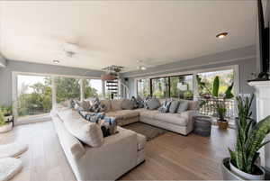 Living room with a ceiling fan and light wood-style floors