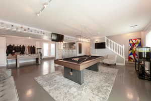 Game room with billiards and concrete floors