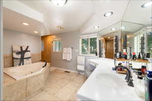 Full bath featuring vanity, a whirlpool tub, light tile patterned floors, tiled shower, and recessed lighting