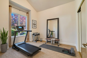 AI Staged as an Exercise room featuring lofted ceiling
