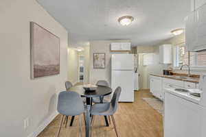 Dining space featuring a textured ceiling and baseboards