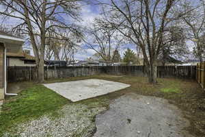 Fenced backyard featuring a patio