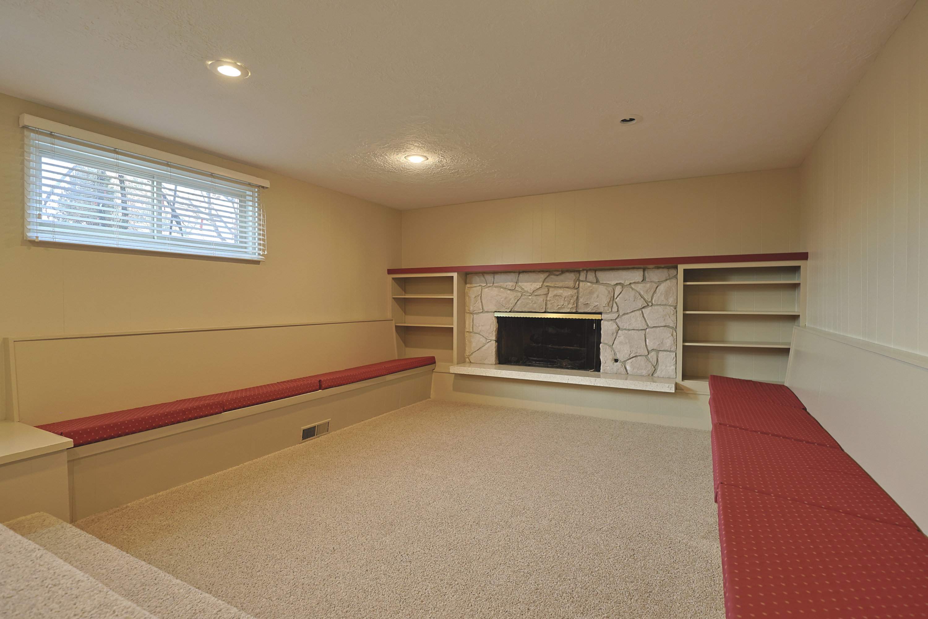 Unfurnished living room featuring a fireplace, carpet, and recessed lighting
