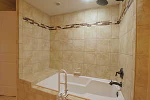 Full bath with a combined bath / shower with rainfall shower
