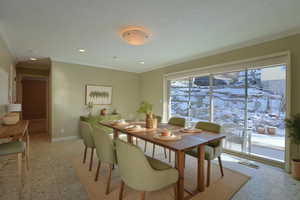 Dining space with ornamental molding and recessed lighting
