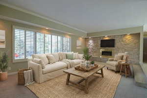 Living area with a stone fireplace, carpet flooring, and ornamental molding