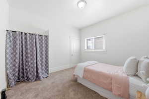 Carpeted bedroom featuring baseboards