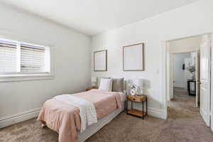 Carpeted bedroom featuring baseboards