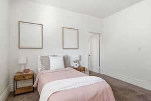 Carpeted bedroom featuring baseboards