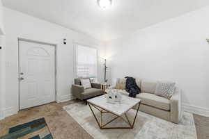 Living room featuring carpet flooring and baseboards