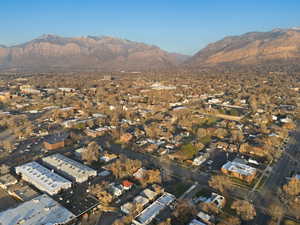 Aerial view of property's location featuring a mountainous background and nearby suburban area