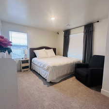 Bedroom with carpet floors and a textured ceiling