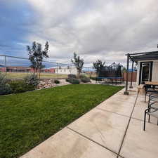 View of yard with a patio area and a trampoline