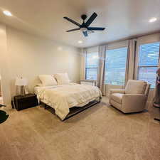 Carpeted bedroom with recessed lighting and ceiling fan