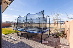 Fenced backyard with a trampoline