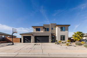 Modern home featuring stucco siding and driveway