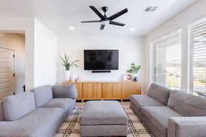 Living area featuring a ceiling fan, recessed lighting, and wood finished floors
