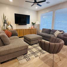 Living area featuring recessed lighting, light wood-style flooring, and a ceiling fan
