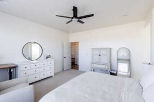Bedroom with a ceiling fan and carpet
