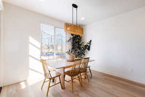 Dining area featuring light wood-style floors and recessed lighting