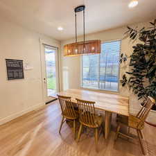 Dining space with light wood-type flooring, plenty of natural light, a textured ceiling, and recessed lighting