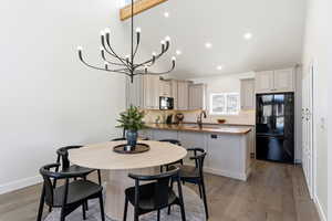 Dining space with light wood-style flooring, a chandelier, and recessed lighting