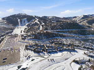 Snowy aerial view featuring a mountain view