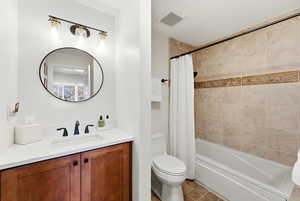 Full bath with vanity and shower / bath combination with curtain
