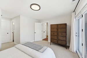 Bedroom with baseboards and light colored carpet