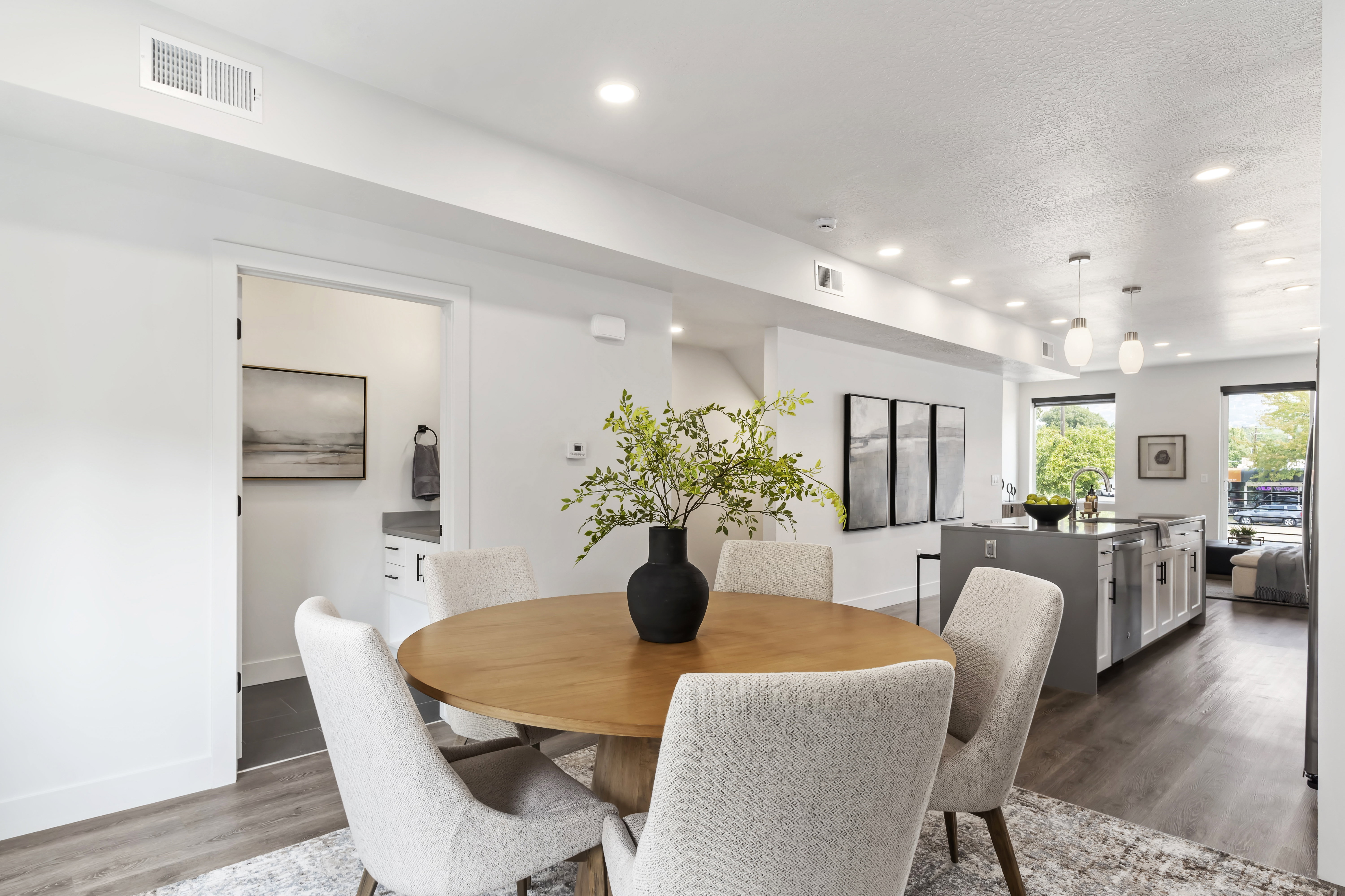 Dining area with wood finished floors, recessed lighting, and a textured ceiling. Model Home