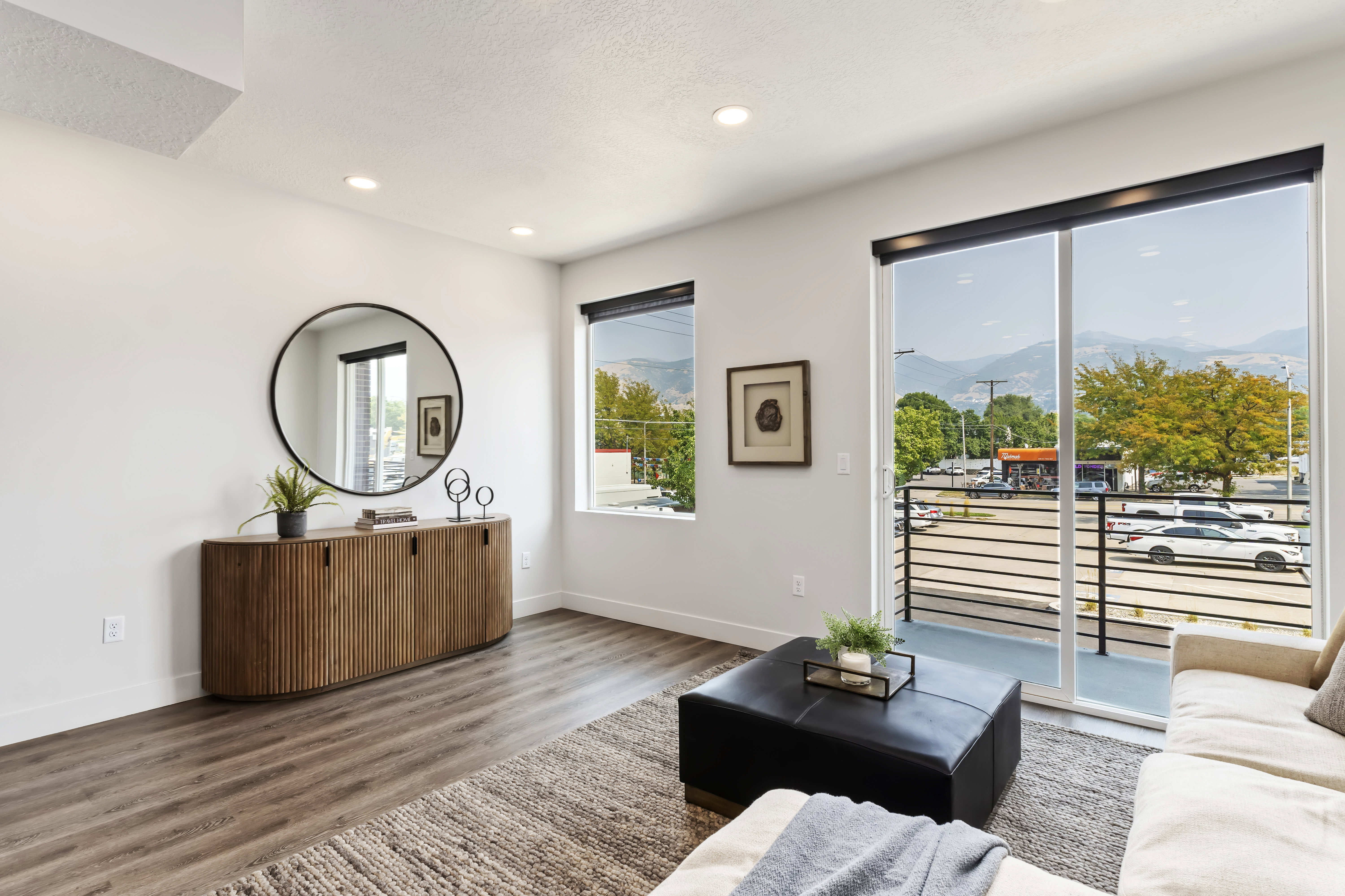 Living area featuring wood finished floors, a mountain view, recessed lighting, and a textured ceiling. Model Home