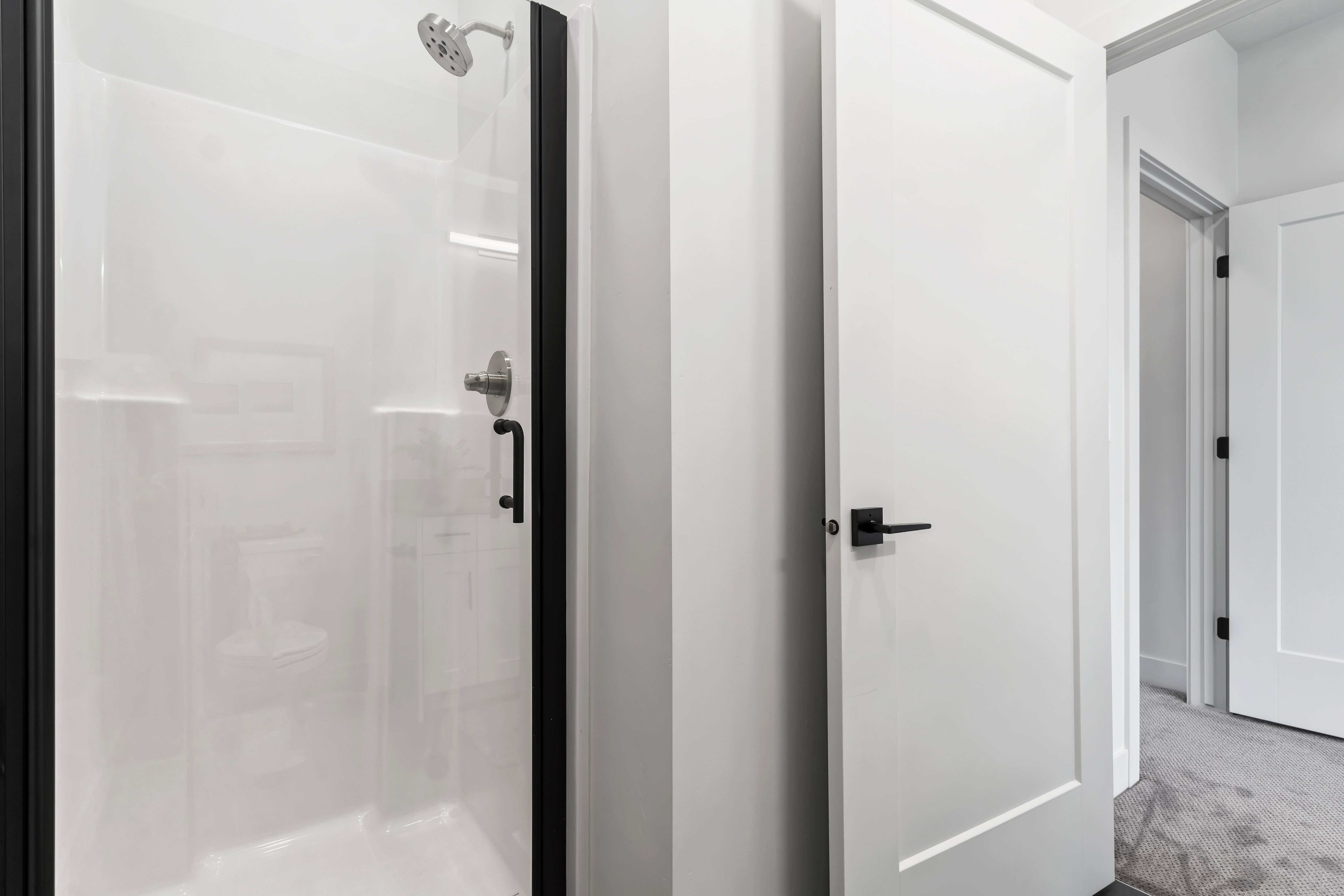 Bathroom with a stall shower and carpet