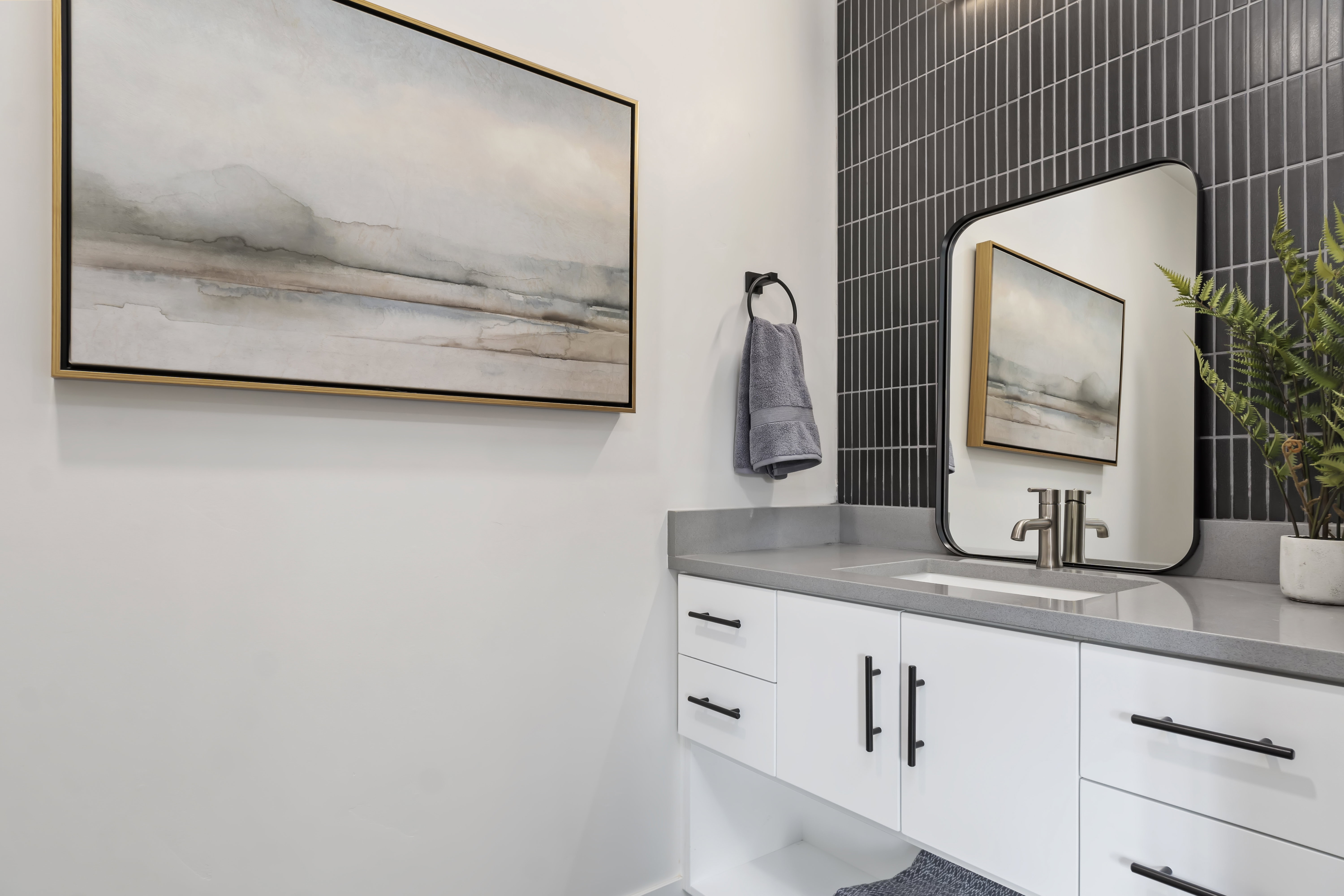 Half bathroom with vanity and baseboards. Model Home