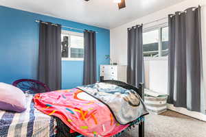 Bedroom featuring ceiling fan and a textured ceiling