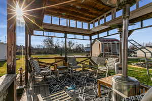 Sunroom featuring healthy amount of natural light and outdoor dining space