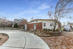 View of front facade featuring brick siding and driveway