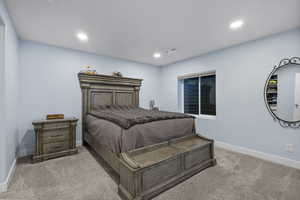 Bedroom with light carpet and recessed lighting