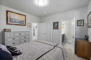 Bedroom featuring light carpet and a closet