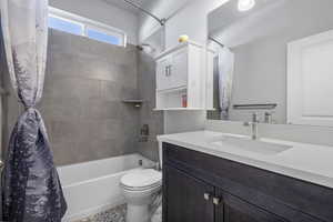 Full bathroom featuring shower / bath combo and vanity