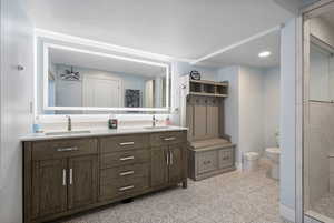 Bathroom featuring double vanity and tiled shower and heated floors