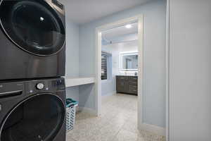 Laundry area featuring stacked washer / drying machine