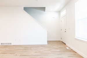 Entrance foyer featuring light wood-style floors and stairway